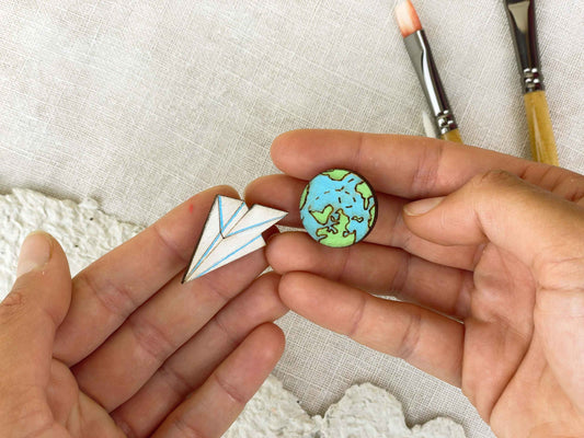 Paired Brooches: World and Paper Plane