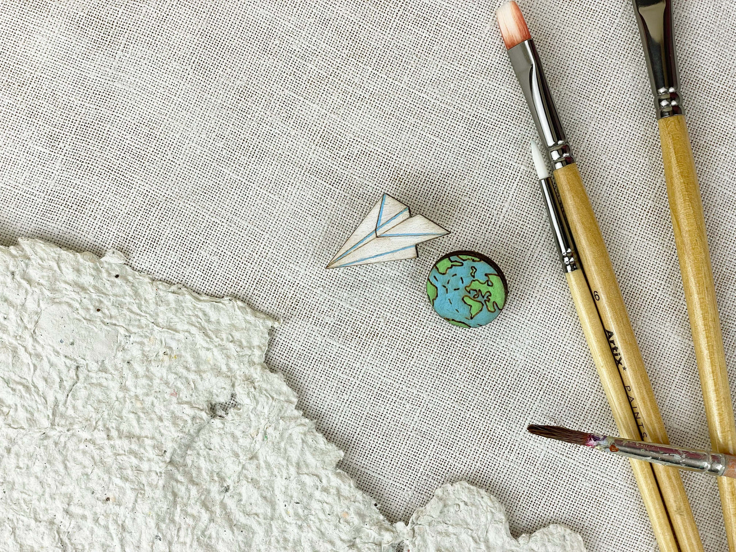 Paired Brooches: World and Paper Plane