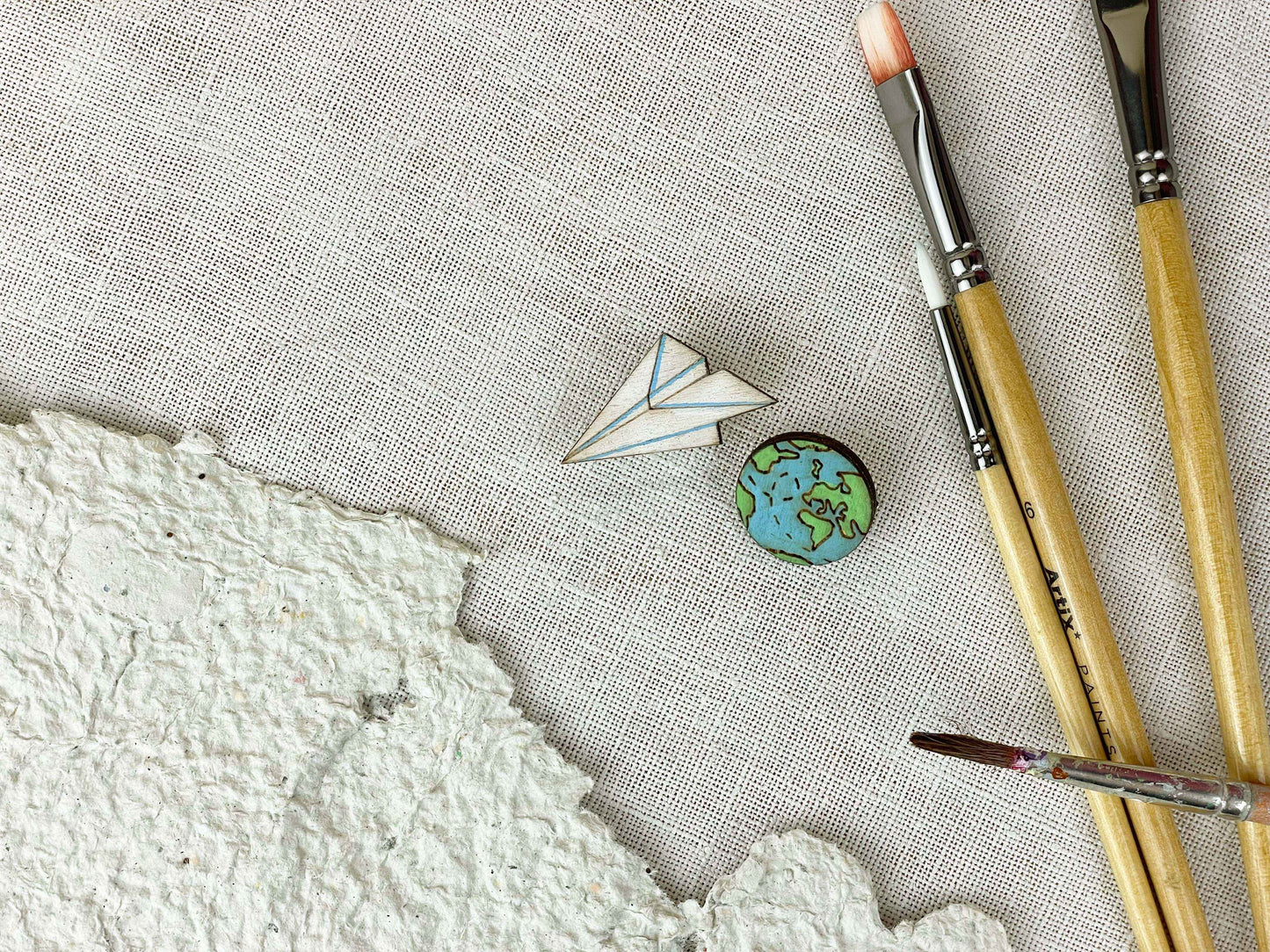 Paired Brooches: World and Paper Plane