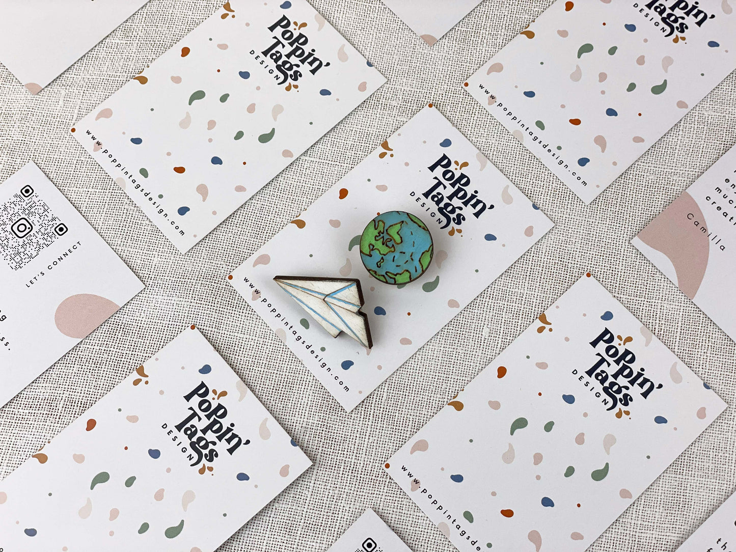 Paired Brooches: World and Paper Plane