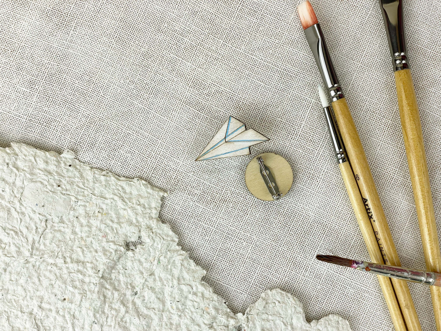 Paired Brooches: World and Paper Plane